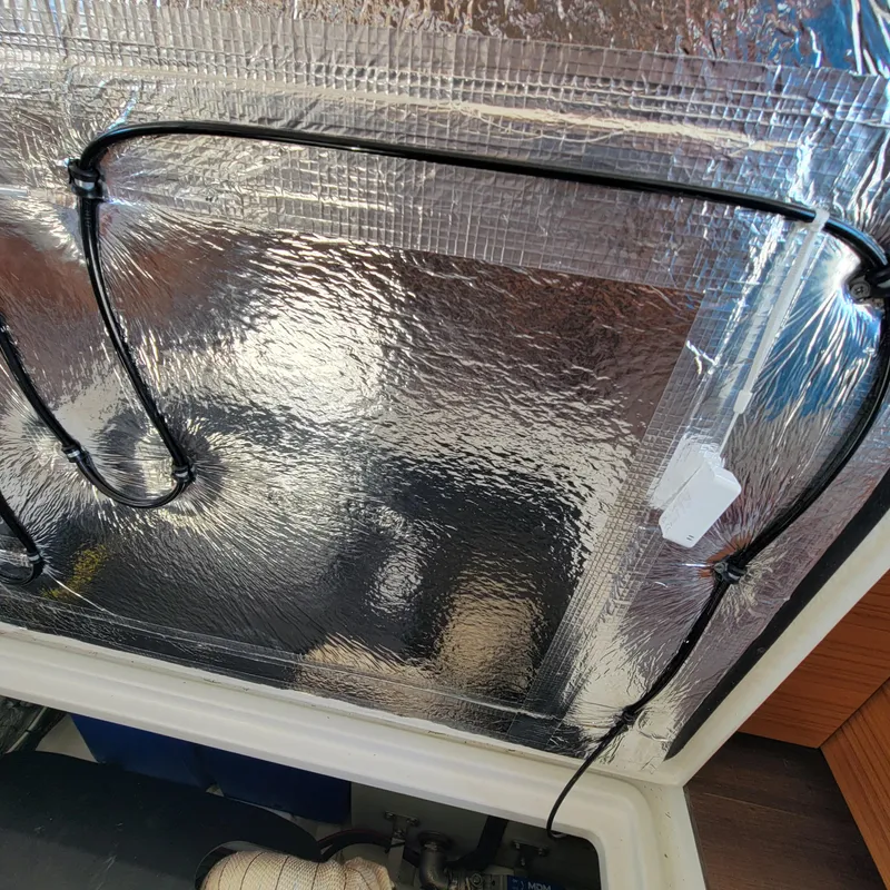 Slide: The Image of Insulated compartment in 2022 Greenline 40 Hybrid boat, featuring reflective material and wiring. - 42