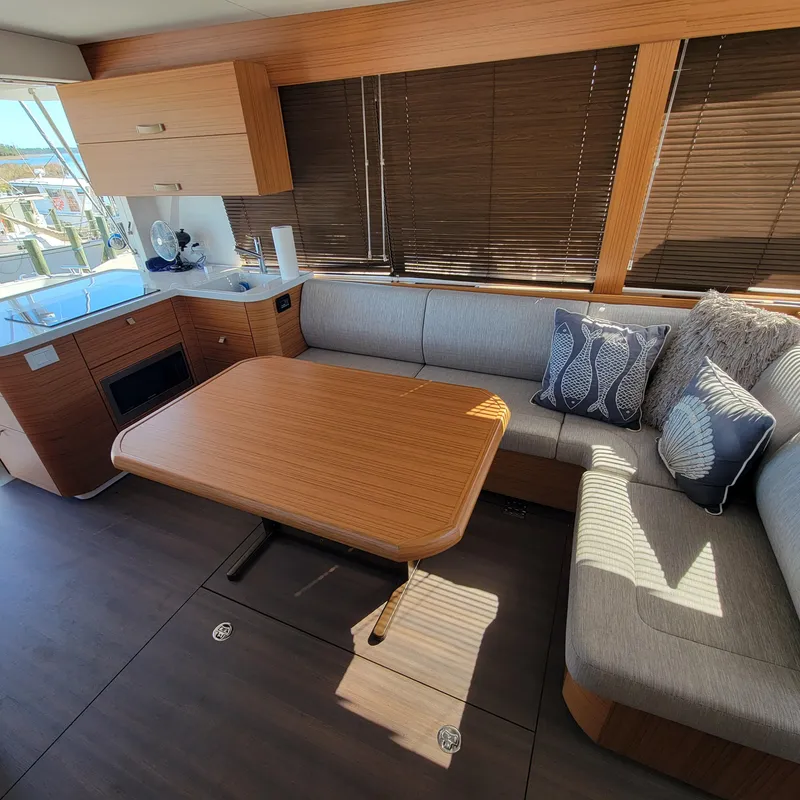Slide: The Image of Interior of 2022 Greenline 40 Hybrid yacht with modern seating and wooden table. - 43