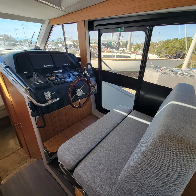 Slide: The Image of Interior of 2022 Greenline 40 Hybrid yacht, featuring helm station and seating. - 46