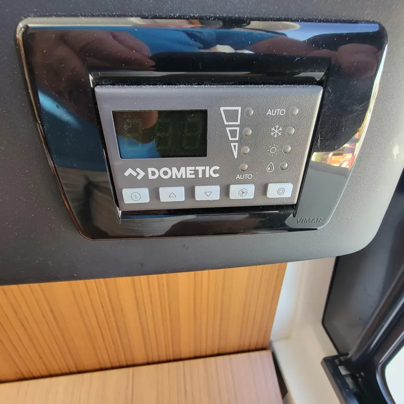 Slide: The Image of Dometic control panel on 2022 Greenline 40 Hybrid yacht interior. - 48
