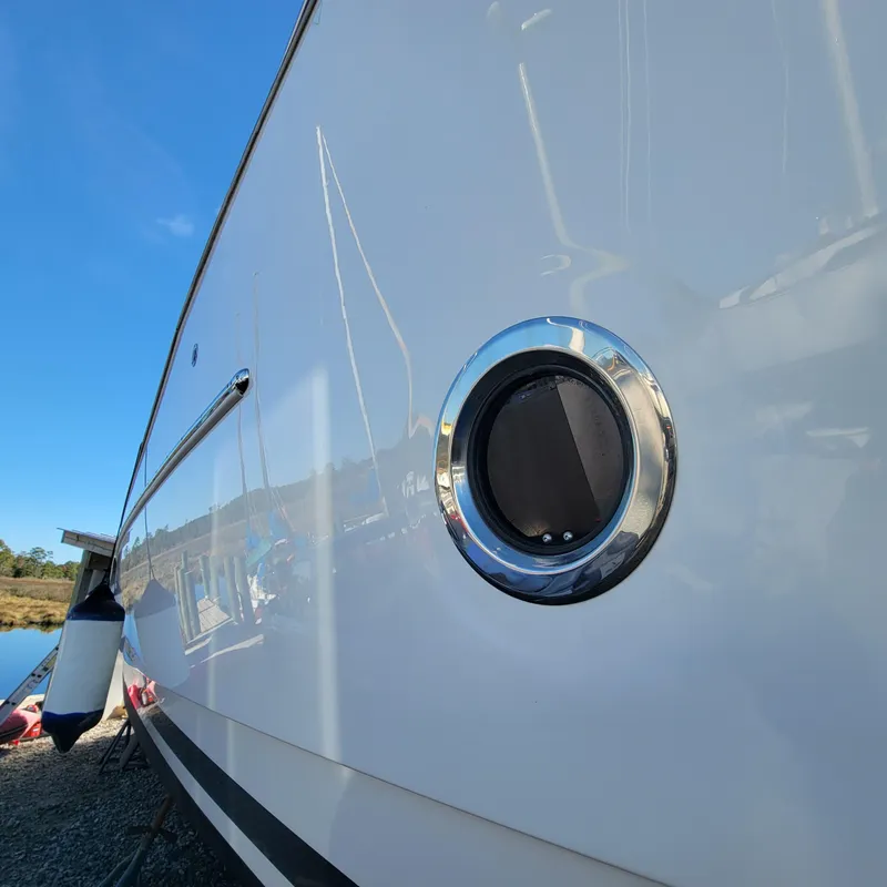 Slide: The Image of 2022 Greenline 40 Hybrid yacht side view with porthole detail. - 7