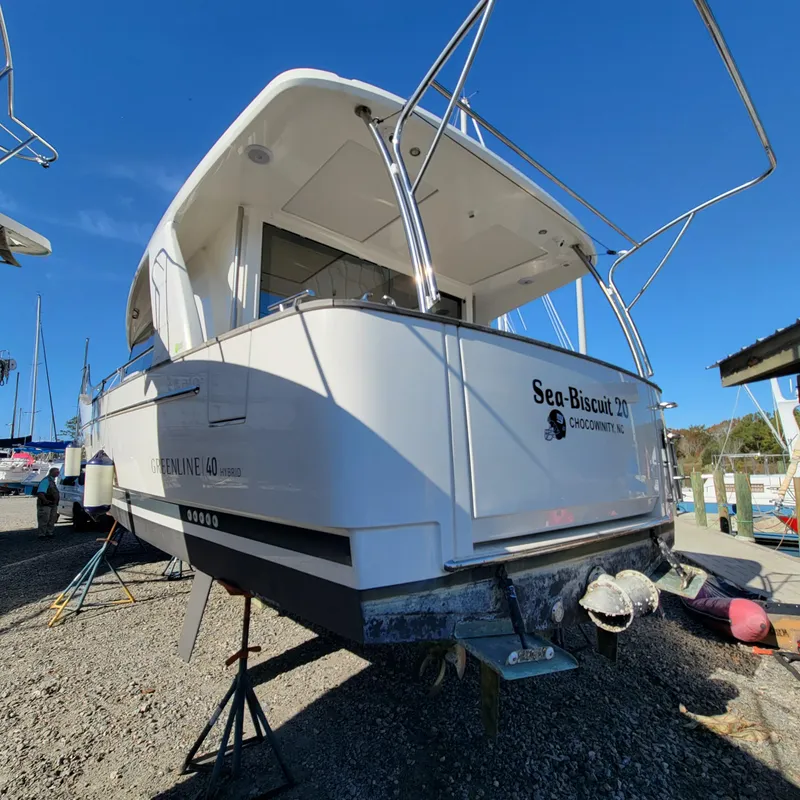 Slide: The Image of 2022 Greenline 40 Hybrid boat on dry dock under clear blue sky. - 9