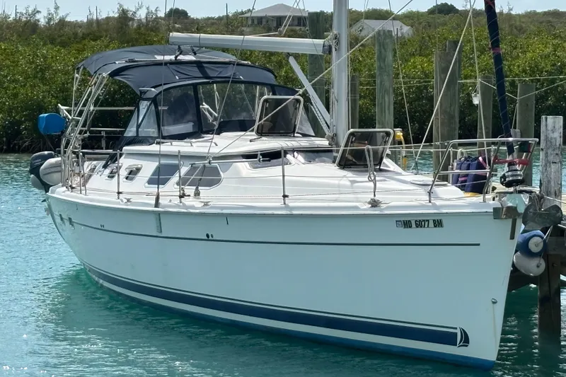 The Image of 2005 Hunter 41 Deck Salon sailboat docked in clear turquoise water. - 0