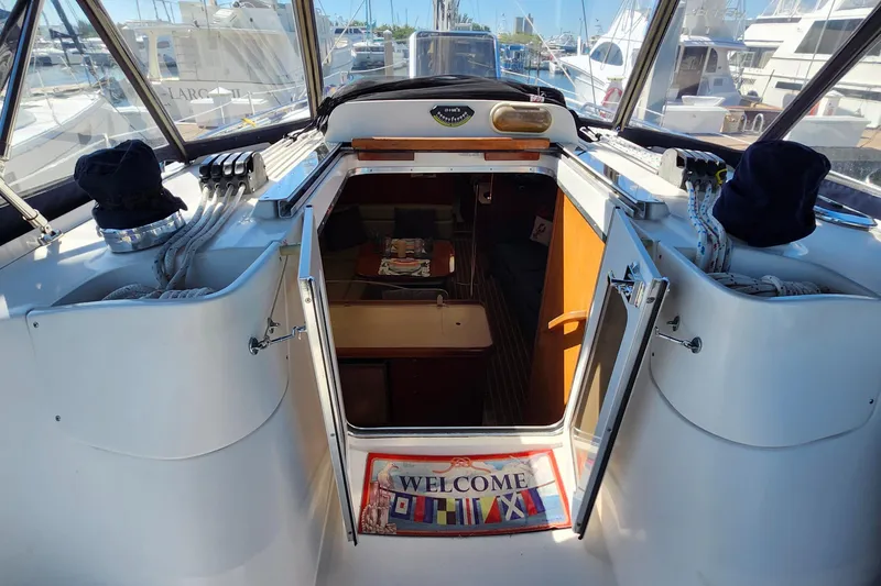 Slide: The Image of Hunter 41 Deck Salon 2005 yacht interior entrance with welcome mat and visible cabin. - 10
