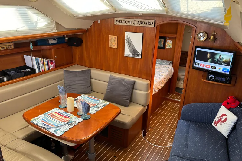 Slide: The Image of Interior of 2005 Hunter 41 Deck Salon yacht with cozy seating and dining area. - 16