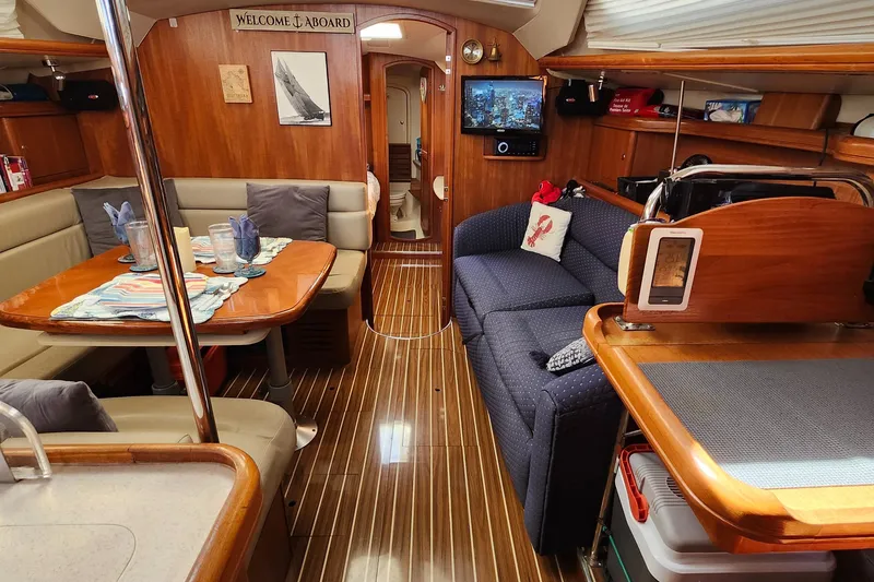 Slide: The Image of Interior of 2005 Hunter 41 Deck Salon yacht with wood finish and cozy seating area. - 17