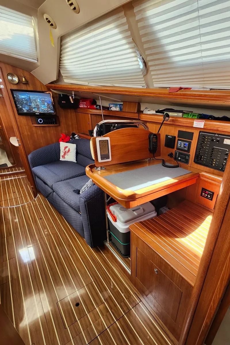 Slide: The Image of Interior of 2005 Hunter 41 Deck Salon with wooden finish and cozy seating area. - 19