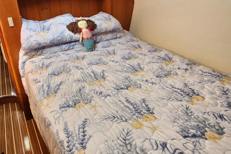 Slide: The Image of Cozy bed with floral bedding and doll in 2005 Hunter 41 Deck Salon yacht cabin. - 22