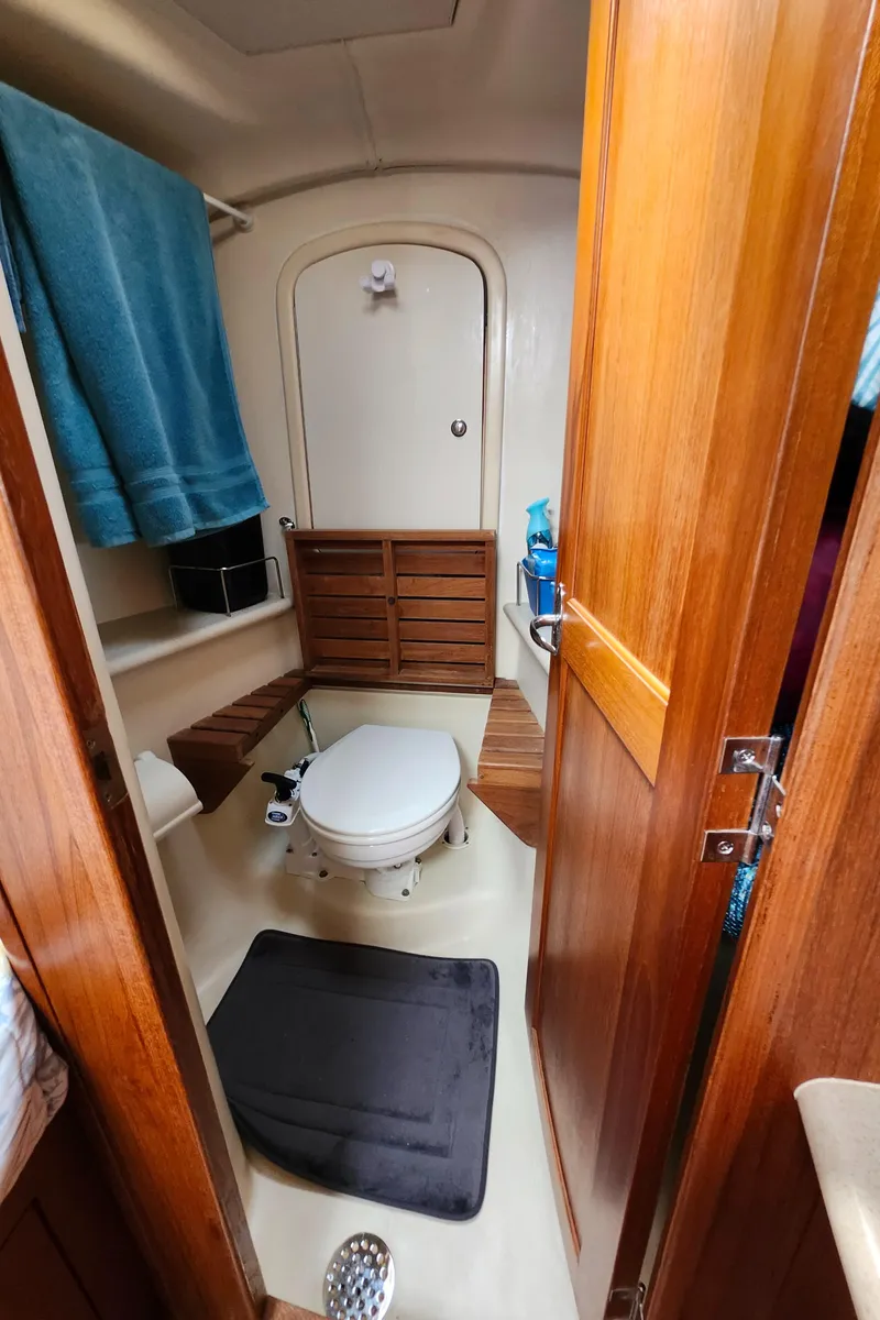 Slide: The Image of 2005 Hunter 41 Deck Salon bathroom with wooden cabinetry and modern fixtures. - 24