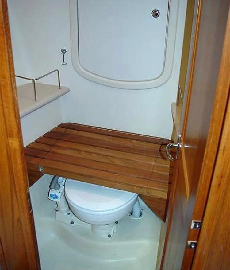 Slide: The Image of 2005 Hunter 41 Deck Salon bathroom with wooden seat cover over toilet. - 27