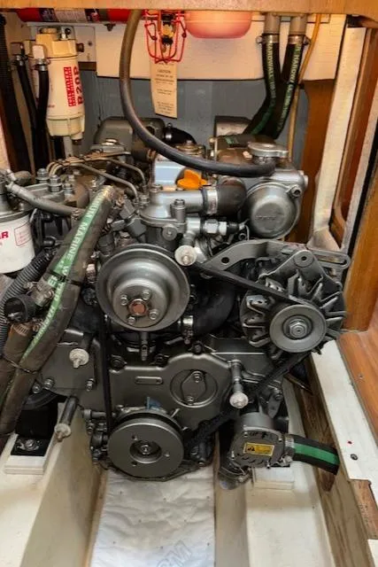 Slide: The Image of Engine compartment of a 2005 Hunter 41 Deck Salon sailboat, showcasing mechanical components. - 30