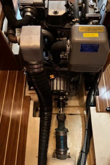 Slide: The Image of Engine compartment of a 2005 Hunter 41 Deck Salon sailboat, showcasing mechanical components. - 31