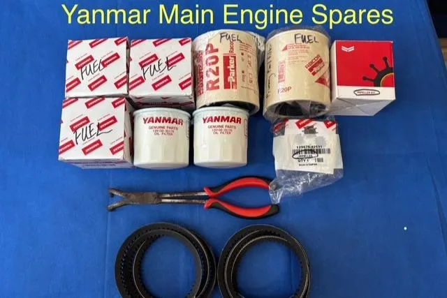 Slide: The Image of Yanmar engine spares including filters, belts, and tools for Hunter 41 Deck Salon 2005. - 32