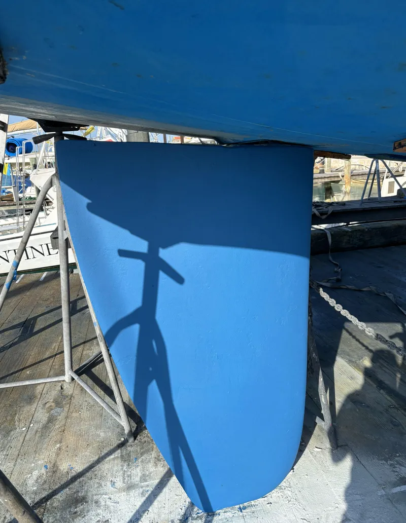 Slide: The Image of 2005 Hunter 41 Deck Salon sailboat keel in dry dock, blue finish. - 35