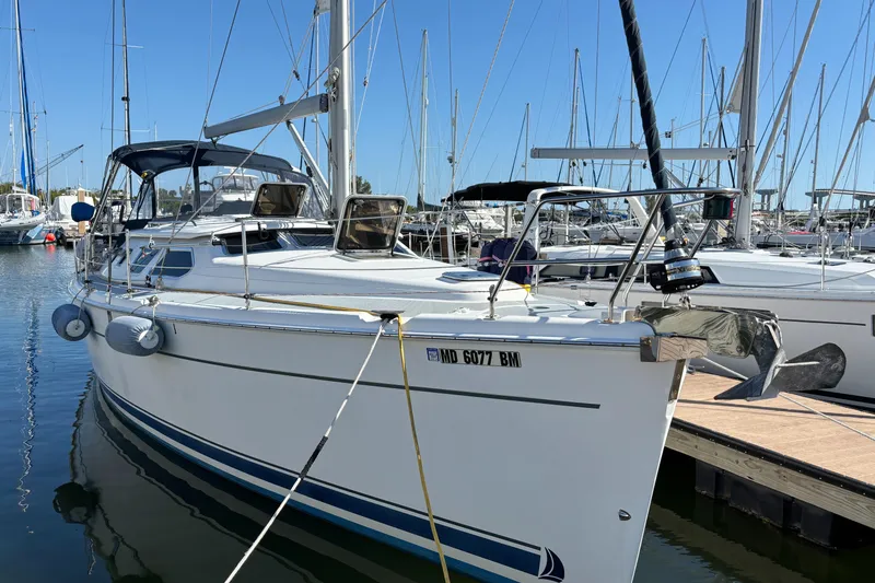 Slide: The Image of 2005 Hunter 41 Deck Salon sailboat docked in marina, clear sky background. - 4