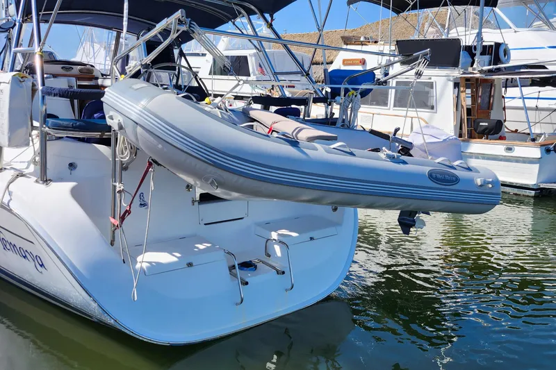 Slide: The Image of 2005 Hunter 41 Deck Salon sailboat with dinghy, docked in a marina. - 5