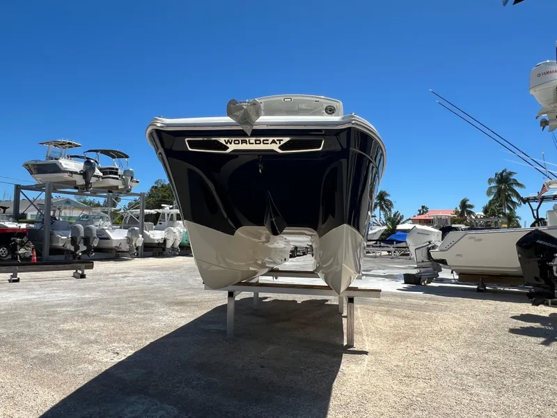 Slide: The Image of 2024 World Cat 260 CC-X boat on display in a sunny marina setting. - 10