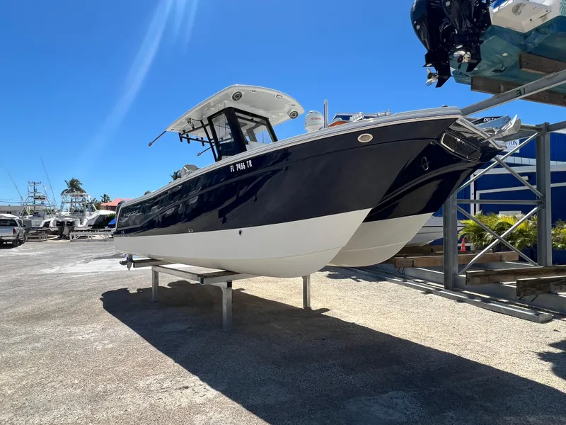 Slide: The Image of 2024 World Cat 260 CC-X boat on display under clear blue sky. - 12