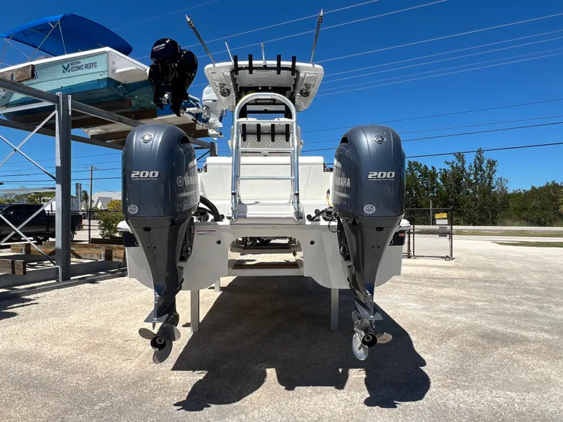 Slide: The Image of 2024 World Cat 260 CC-X boat with dual Yamaha 200 engines, parked outdoors. - 15