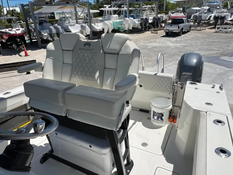 Slide: The Image of 2024 World Cat 260 CC-X boat interior with dual seats and steering wheel. - 17