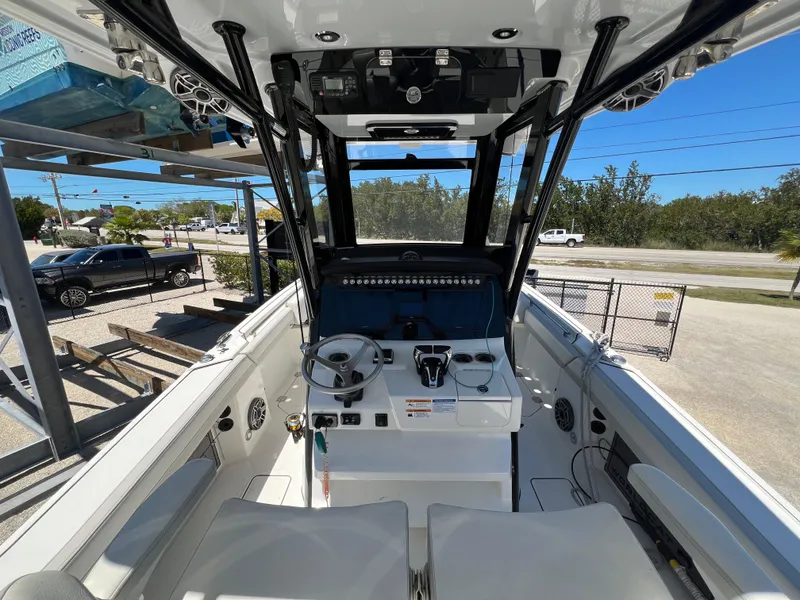 Slide: The Image of 2024 World Cat 260 CC-X boat interior with helm, steering wheel, and seating. - 19