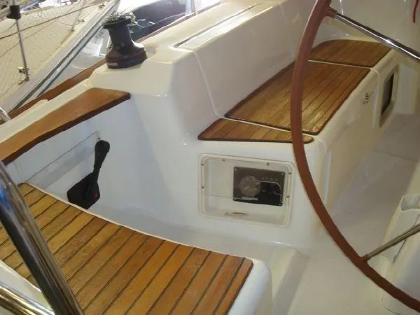 Slide: The Image of Cockpit of 2010 Jeanneau Sun Odyssey 36i with wooden seating and steering wheel. - 10