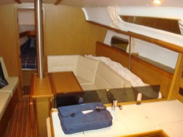Slide: The Image of Interior of 2010 Jeanneau Sun Odyssey 36i sailboat with cozy seating and wooden finishes. - 11