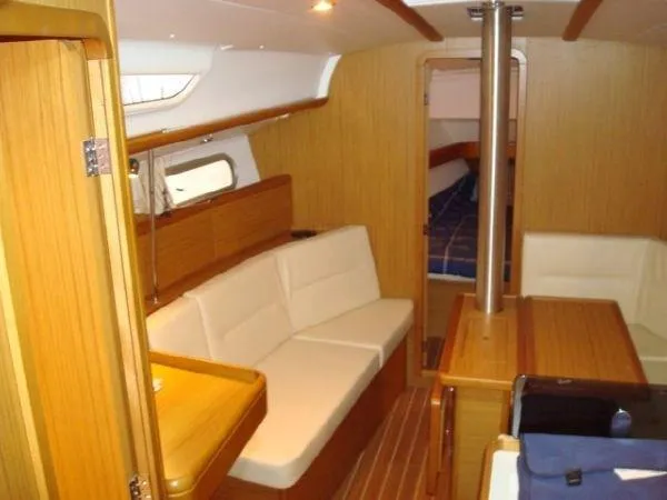 Slide: The Image of Interior of 2010 Jeanneau Sun Odyssey 36i yacht with wooden finish and white seating. - 12