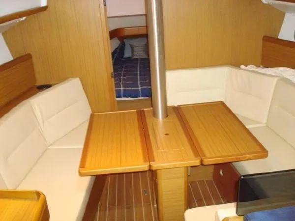 Slide: The Image of Interior of 2010 Jeanneau Sun Odyssey 36i sailboat with wooden table and seating. - 14
