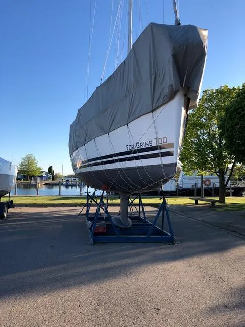 Slide: The Image of 2010 Jeanneau Sun Odyssey 36i sailboat covered and docked on a stand. - 6
