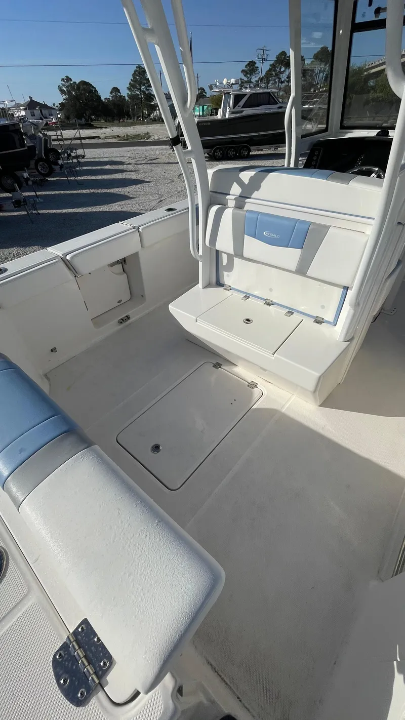 Slide: The Image of 2023 Robalo R272 Center Console boat interior with seating and storage compartments. - 23