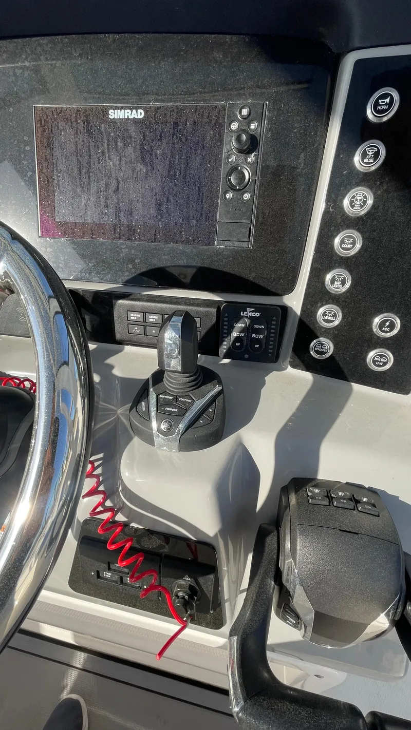Slide: The Image of 2023 Robalo R272 Center Console dashboard with steering wheel and control panel. - 25