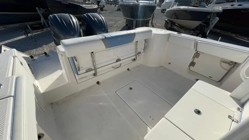 Slide: The Image of 2023 Robalo R272 Center Console boat interior with dual engines and spacious seating. - 27