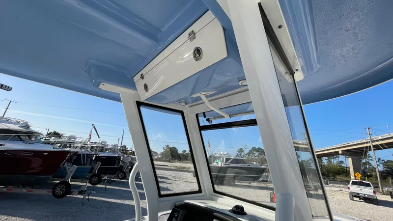 Slide: The Image of 2023 Robalo R272 Center Console boat interior with blue ceiling and windows. - 28