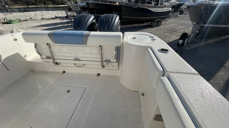 Slide: The Image of 2023 Robalo R272 Center Console boat interior with dual engines, docked outdoors. - 35