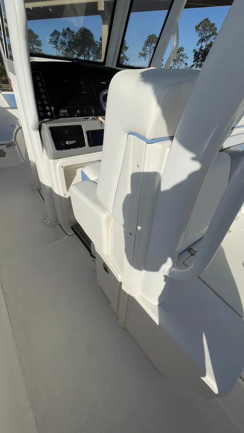 Slide: The Image of 2023 Robalo R272 Center Console interior with white seating and control panel. - 39