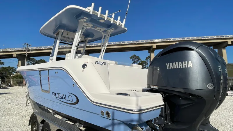 Slide: The Image of 2023 Robalo R272 Center Console boat with Yamaha engine, parked outdoors. - 4
