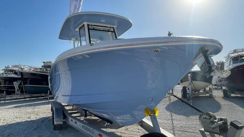 Slide: The Image of 2023 Robalo R272 Center Console boat on trailer, displayed outdoors. - 5