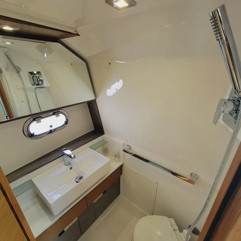 Slide: The Image of 2021 Tiara Yachts 38 LS bathroom with modern sink, mirror, and showerhead. - 34