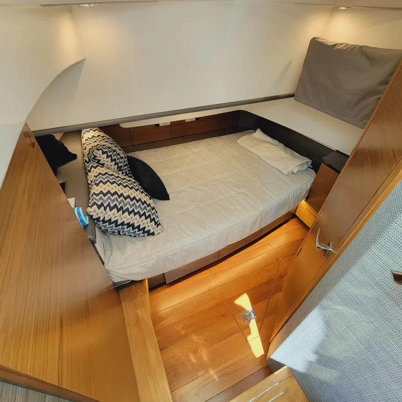 Slide: The Image of 2021 Tiara Yachts 38 LS cabin interior with bed and wooden finish. - 36