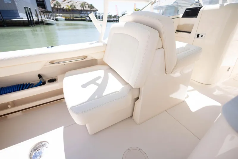 Slide: The Image of 2021 Grady-White Freedom 275 boat interior with white seating and sleek design. - 16