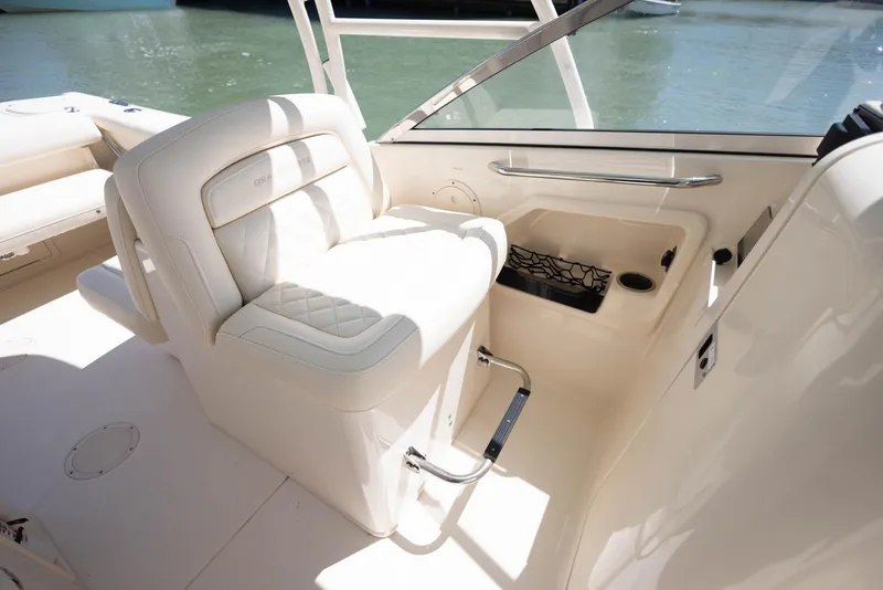 Slide: The Image of 2021 Grady-White Freedom 275 boat interior with white seating and water view. - 23