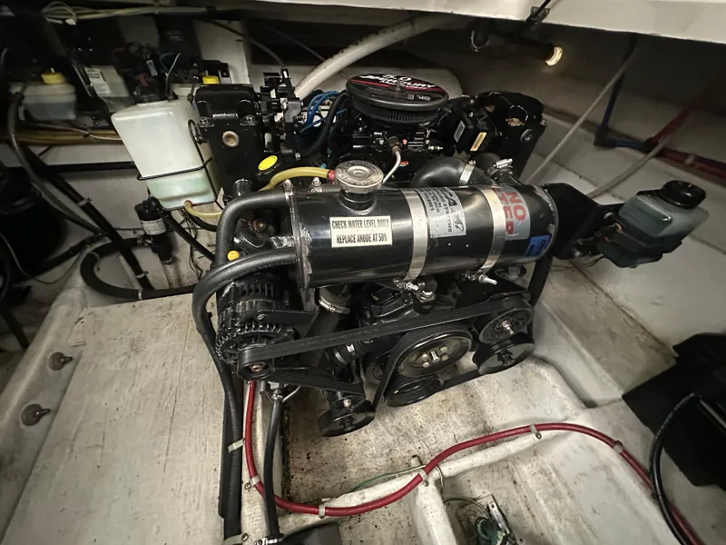 Slide: The Image of Engine compartment of a 2005 Bayliner 305 boat, showcasing detailed mechanical components. - 15