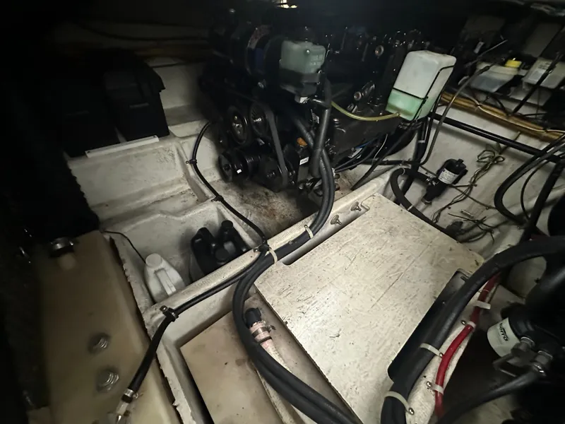 Slide: The Image of Engine compartment of a 2005 Bayliner 305 boat, showing mechanical components and wiring. - 16
