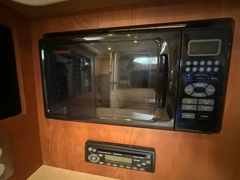 Slide: The Image of Microwave and stereo system in 2005 Bayliner 305 boat interior. - 21