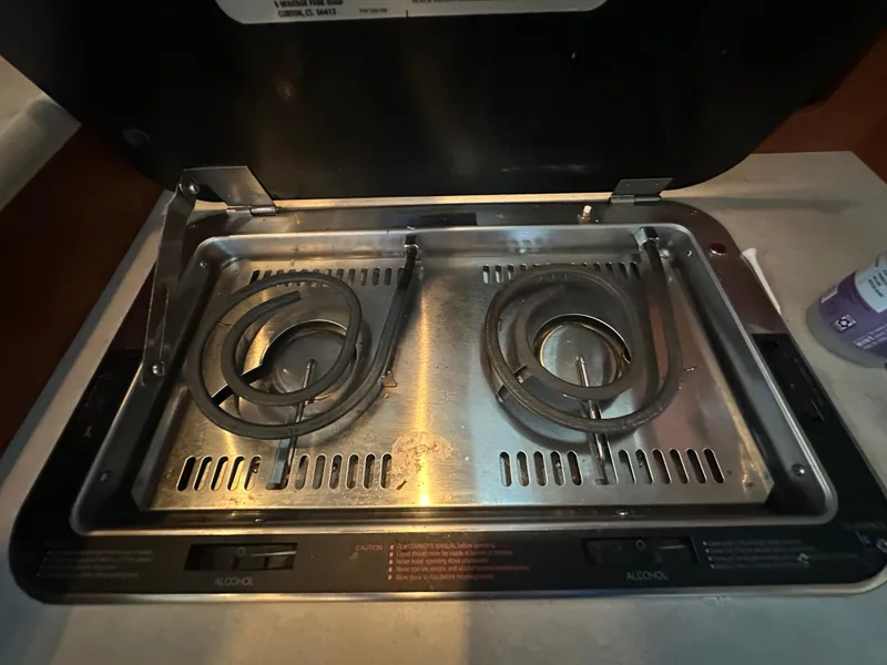 Slide: The Image of Electric stove in 2005 Bayliner 305 boat kitchen, featuring dual coil burners. - 24