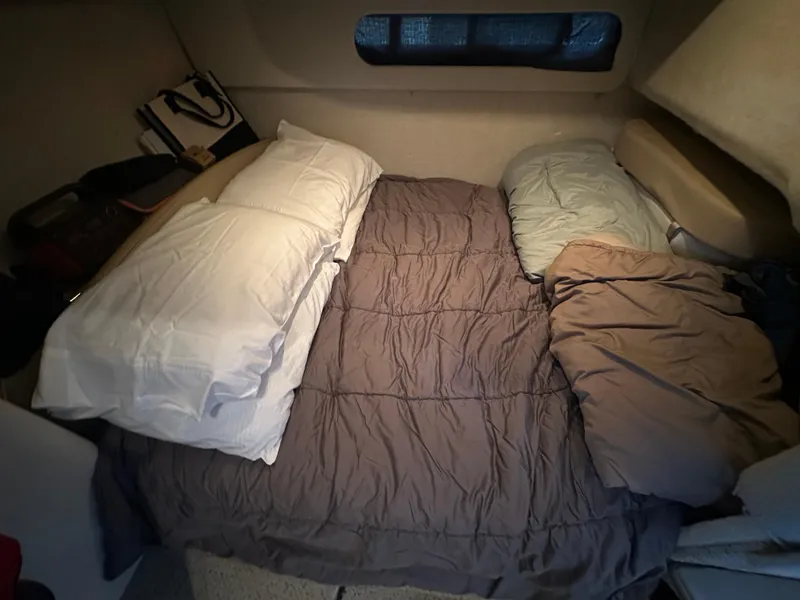 Slide: The Image of Cozy sleeping area inside a 2005 Bayliner 305 boat cabin with pillows and bedding. - 30