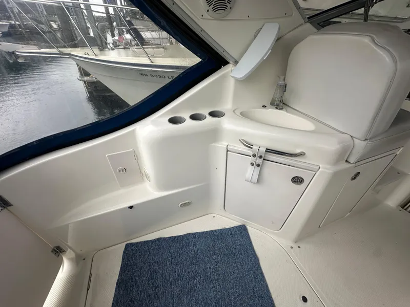 Slide: The Image of 2005 Bayliner 305 boat interior with white seating and storage compartments. - 7
