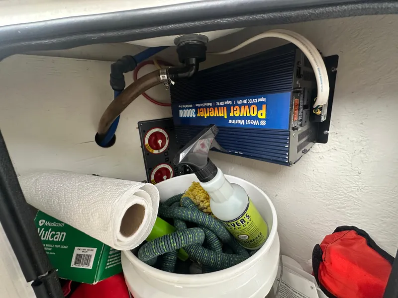 Slide: The Image of Storage compartment in a 2005 Bayliner 305 with power inverter and cleaning supplies. - 8