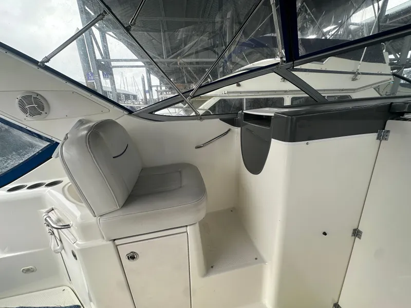 Slide: The Image of 2005 Bayliner 305 boat interior with helm seat and dashboard under canopy. - 9